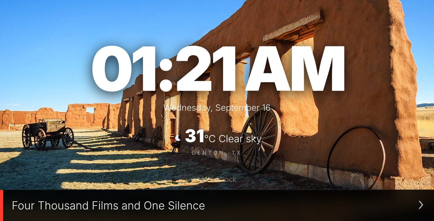 MeteoClock in landscape: the time in large white type over a photo, with a news headline scrolling along the bottom